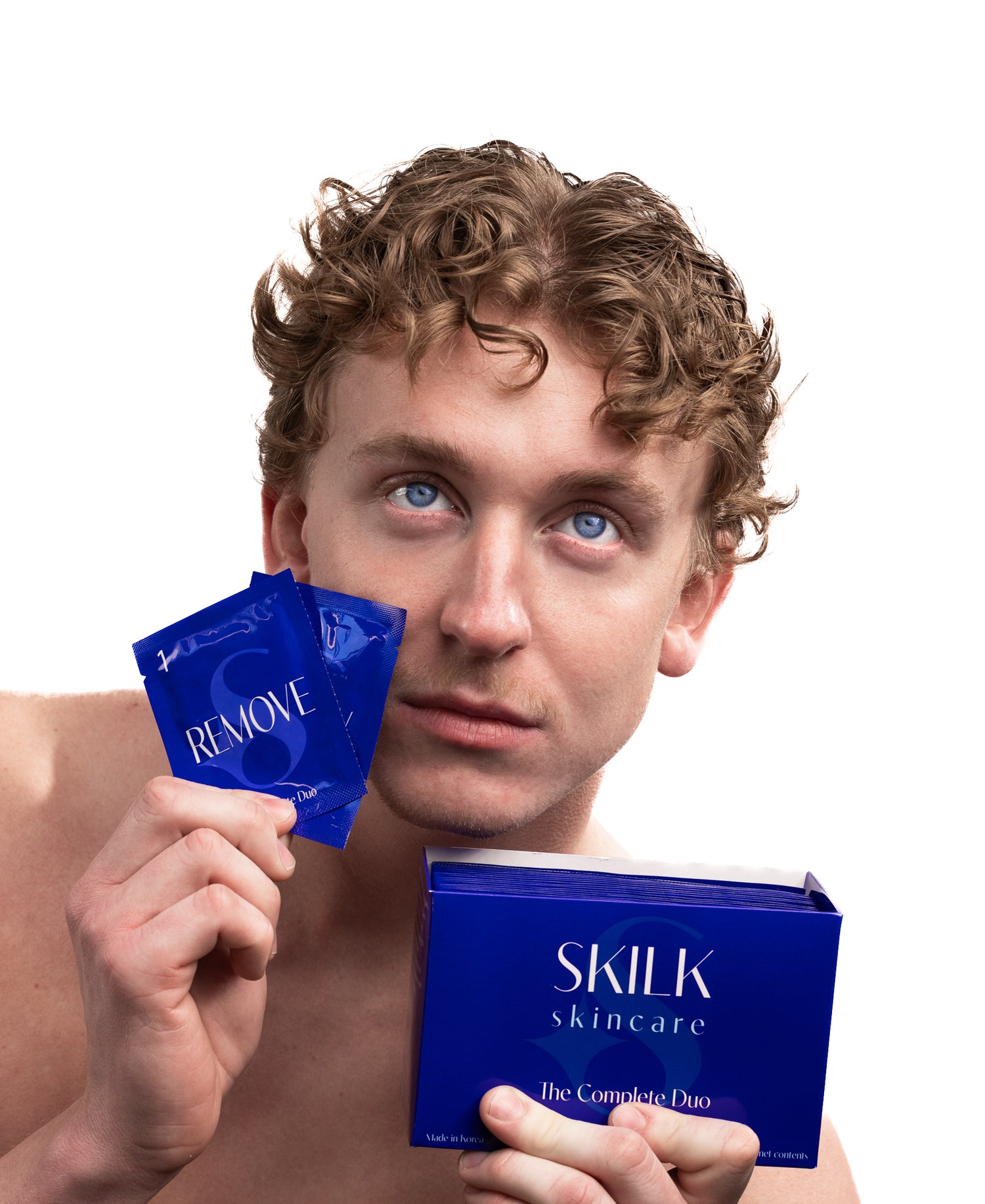 Man holding Skilk Skin products against a white background