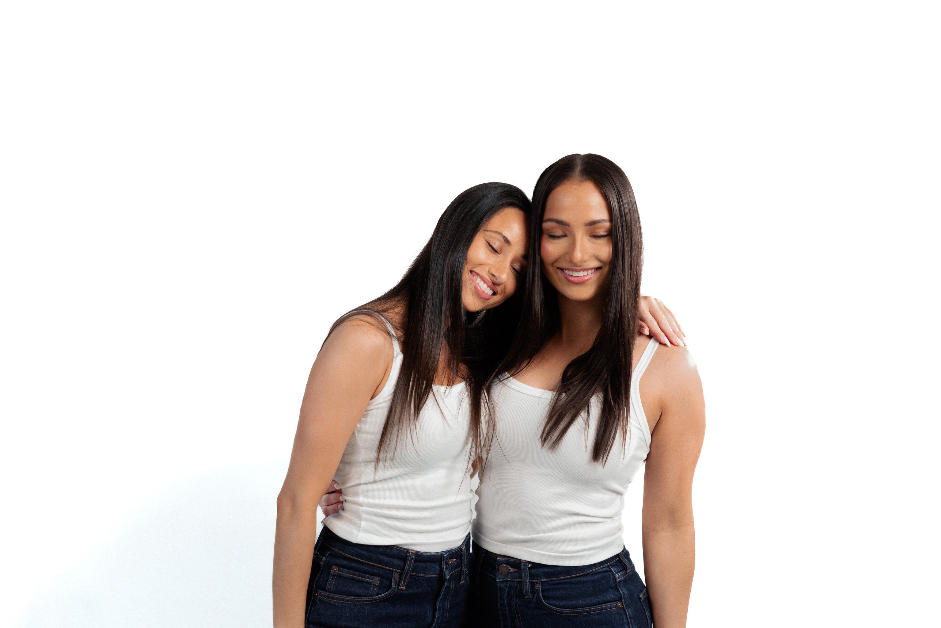 Skilk Skin founders Jordan and Blake Skilken posing together in white tops and jeans